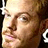 A pixelated close-up of a person's face showing light skin, brown eyes, and short hair with visible mouth and nose details.