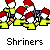 Pixelated image of multiple figures in red hats and yellow outfits with white faces, labeled 'Shriners' below.