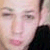 Pixelated close-up of a person's face with closed eyes, pink lips, and dark clothing visible on the right side.