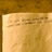 Static 48x48 pixel icon with a beige background and brown text-like shapes, appearing as an aged or faded document fragment with no clear subjects or objects visible.