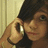 A pixelated image shows a person holding a phone to their ear against a light-colored wall, with text reading "Deanna I Love You" on a dark background.