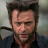 Static 48x48 pixel buddy icon showing a close-up of a man's face with dark hair and stubble, wearing a dark jacket over a red shirt against a blurred background.