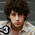 A person with curly brown hair wearing a light-colored patterned shirt appears in three views with a black and white '3' symbol in the bottom-left corner of the top-left view.