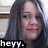 Pixelated close-up of a person with long dark hair, pinkish skin tone, and visible facial features including eyes, nose, mouth, and eyebrows.