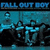 Pixelated image of a band performing with text 'FALL OUT BOY' split across four corners on black background.