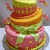 Pixelated image of a jar with layered contents, featuring green and pink hues on the container and golden-brown layers inside.