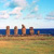 Pixelated landscape showing five vertical stone structures on a grassy field with blue water and sky background.