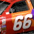 Animated sequence of a red and orange race car with white number 66, showing motion blur effects