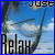 Pixelated static image with blue border showing partial text 'JOSE' top-right, 'Relax' bottom-left, and a curved dark shape against blue sky with white clouds.