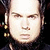 Static pixelated image of a person's face with visible facial features and dark hair against a black background.