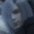 Pixelated grayscale image of a stylized face with dark hair, light skin tones, and blurred features against a blue-gray background.