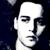 Pixelated grayscale portrait of a person with short dark hair, closed eyes, and neutral expression against dark background.