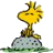 Pixelated yellow cartoon bird perched on a gray rock with green base, static single-frame image.
