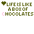Animated text-based icon with green and pink pixelated letters forming 'LIFE IS LIKE A BOX OF CHOCOLATES' repeated , each preceded by a small heart symbol