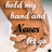 A pixelated image of a person with light brown hair and fair skin, wearing a white top, holding up text that reads 'hold my hand' above the name 'Nancy'.