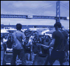 Animated sequence showing two figures walking away from the viewer toward a crowd, with changing text overlays above them.