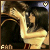 Animated sequence of two figures in a close embrace, one figure's hand on the other's face with visible heart symbols and 'FAN' text at bottom.