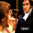 Pixelated image of two figures: one with long brown hair in a white dress, the other in a dark suit with a white shirt and blue tie, standing close together against a black background.