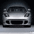 Pixelated grayscale image of a front-facing car with headlights, grille, and windshield visible against dark background.