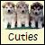 Three pixelated dogs stand side-by-side on a light background with the word 'Cuties' below them.