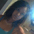 A person with dark hair and a teal top appears in a of four , with the bottom-right empty