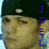 Animated contact sheet of a person wearing a dark cap with white dot, showing six frames where vertical text alternates between blue and orange colors.
