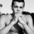 Pixelated grayscale image of a shirtless person with short dark hair, standing in front of a light background.