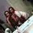 Two people embrace on a bed with white sheets; text overlays change from 'BES' to 'BESTIES BITCHHES' in pixelated font.