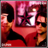 Two people in red and black clothing stand against a pink background with a star-shaped frame; text labels 'MARGER' and 'DUNN' appear at top and bottom.