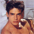 Static pixelated image of a shirtless man with dark hair holding a wine glass against a light background.