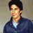 A pixelated figure in a blue jacket and light shirt appears in three sequential poses against a muted background.