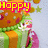 Pixelated birthday cake with green and orange layers, pink flowers, yellow stars, and red-yellow text reading 'Happy Birthday To Me' on a light blue background.