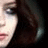 A pixelated image of a person with dark hair and light skin, accompanied by brown text reading "a girl" above and "too sad to give a care" below.