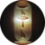 Circular icon with dark outer ring and central vertical golden-brown cylinder featuring pixelated hieroglyphic symbols.