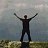 A pixelated buddy icon featuring a silhouetted figure with arms raised against a cloudy sky, paired with text reading "live your life with arms wide open" on a muted green background.