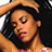 Pixelated static image of a person with dark hair wearing a light brown hat, visible in close-up crop on orange-toned background.