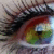 A pixelated close-up of a human eye with visible eyelashes, iris details in brown and green hues, and surrounding skin tones.