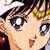Anime-style character face with large expressive eyes, dark hair, and a small open mouth showing a pink tongue, rendered in pixelated style.