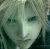 Pixelated green-toned image of a face with indistinct features and blurred background elements.