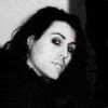 Black-and-white animated sequence showing four distinct band member poses with expressive singing gestures and dynamic hair movement.