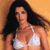Static pixelated image of a woman in a white bikini top against an orange background with long dark hair flowing to the right.