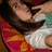 Pixelated image of a person with long brown hair wearing white and green clothing, next to red text reading "Melina Loves You! <33" on black background.