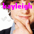 A pixelated image of a person with brown hair wearing a dark jacket over a light blue shirt, resting their chin on one hand against a white background.