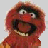 A pixelated contact sheet showing two frames of an animated icon featuring a red Muppet-like character with wide eyes and open mouth next to bold black text reading "I what do... EAT DRUMS!" on a white background.