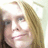 Pixelated image of a person with long light brown hair on the left, next to pink pixelated text reading 'you just gotta love her' on a pale background.