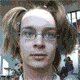 Animated sequence showing a person with light brown hair in two ponytails, wearing glasses and a dark maroon shirt, transitioning through multiple facial expressions and head angles.