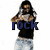 A pixelated image of a person with long hair wearing a black shirt and light blue jeans, holding an object near their face.
