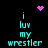 Pixelated cyan text reads 'i luv my wrestler' on black background with pink heart and starburst symbols.