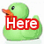 Green rubber duck with orange beak and black eye, white duck with orange beak and black eye, red 'Here' text, pink 'is an' text, purple 'Example' text, green striped background, gray background.