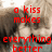 Red pixelated text reads 'a kiss makes everything better' over a blurred background with indistinct shapes and muted tones.